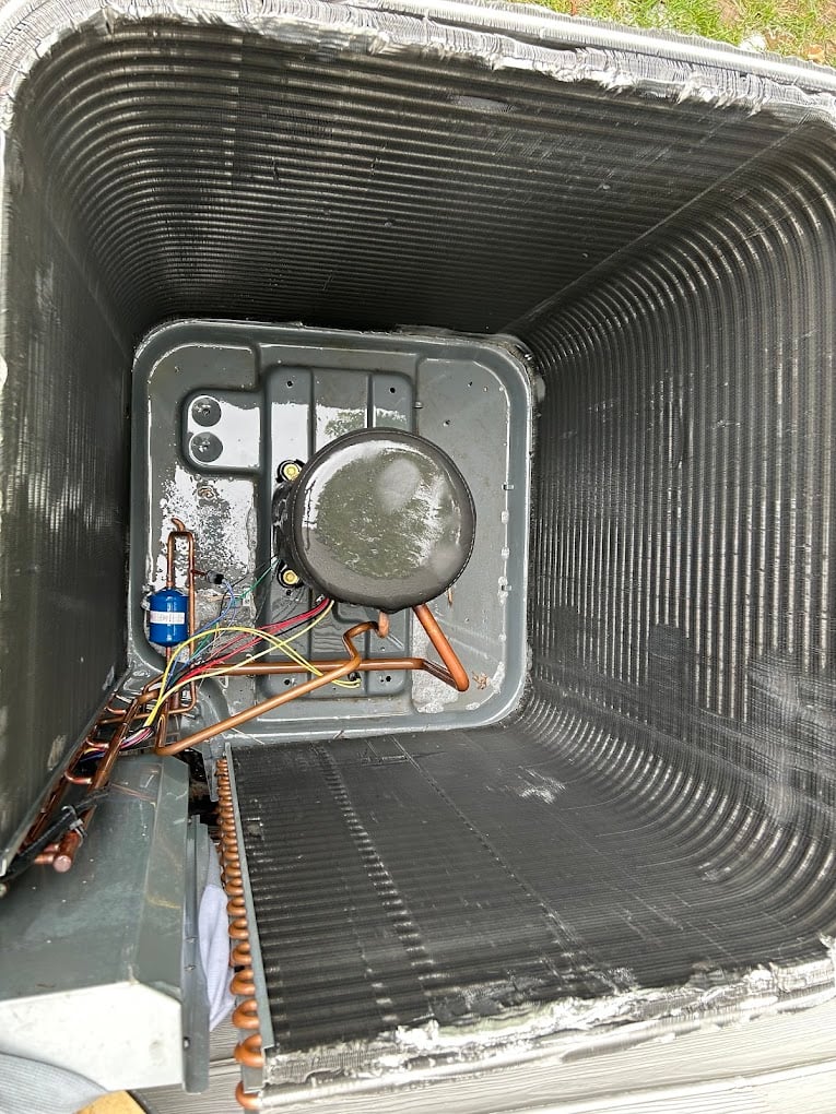 Interior view of a newly installed evaporator coil cabinet with sealed seams and clean copper linework.