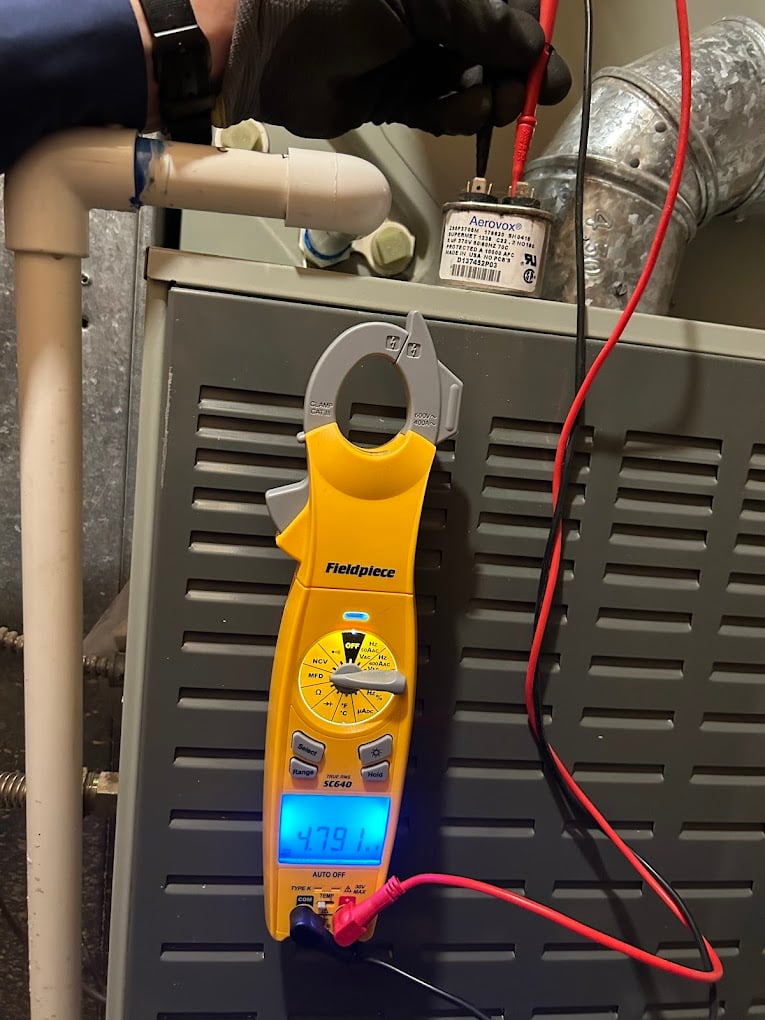 Fieldpiece SC640 clamp meter reading a run-capacitor value during commissioning of a newly installed HVAC system.