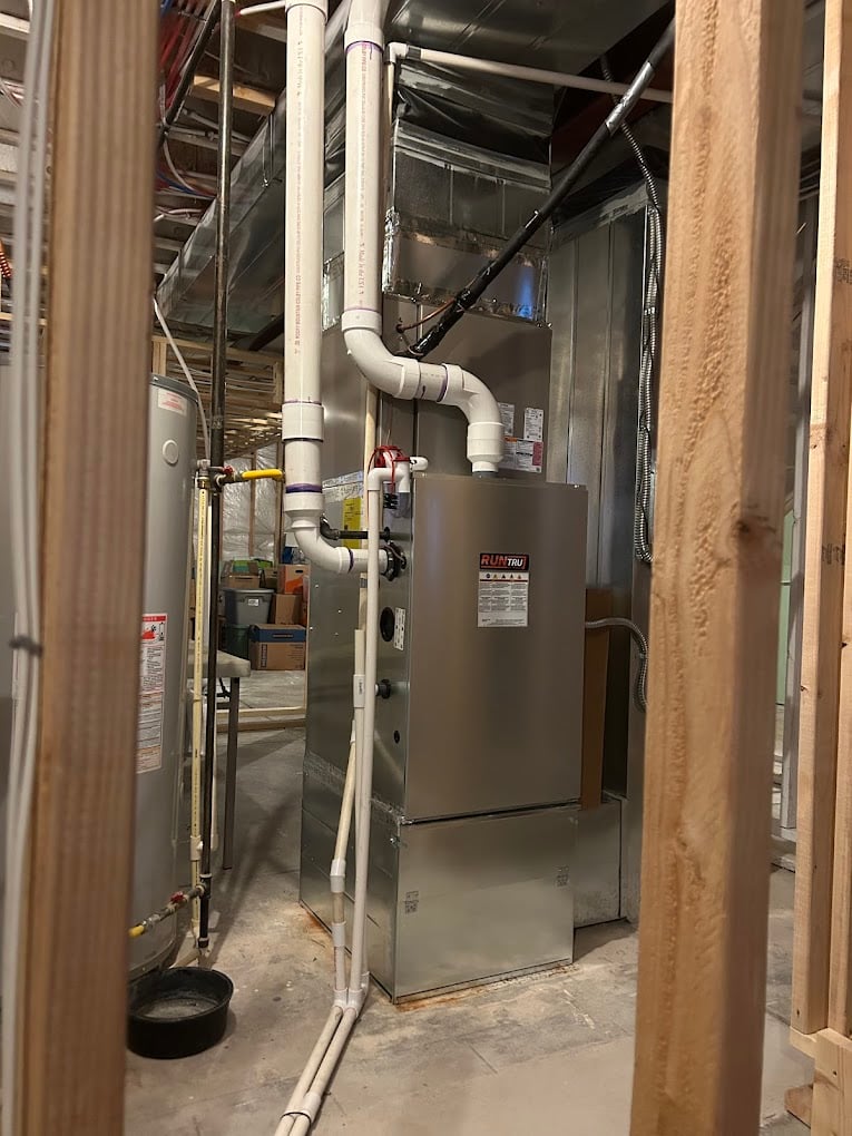 Copper line-set connections at the service port of a newly installed outdoor AC condenser.