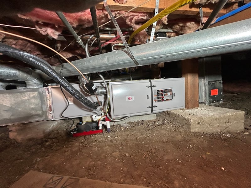 Air handler and return ducting installed in a home crawlspace with insulated flex lines and clean condensate routing.