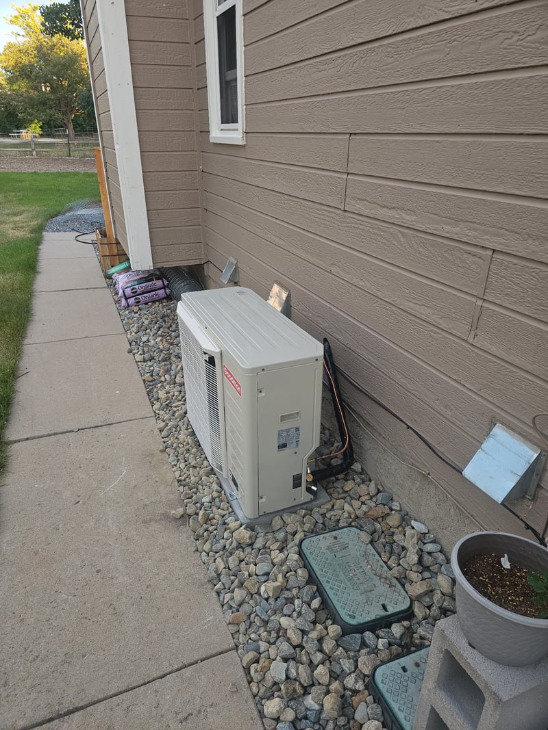 Daikin furnace installed beside a new gas water heater in a residential utility closet.