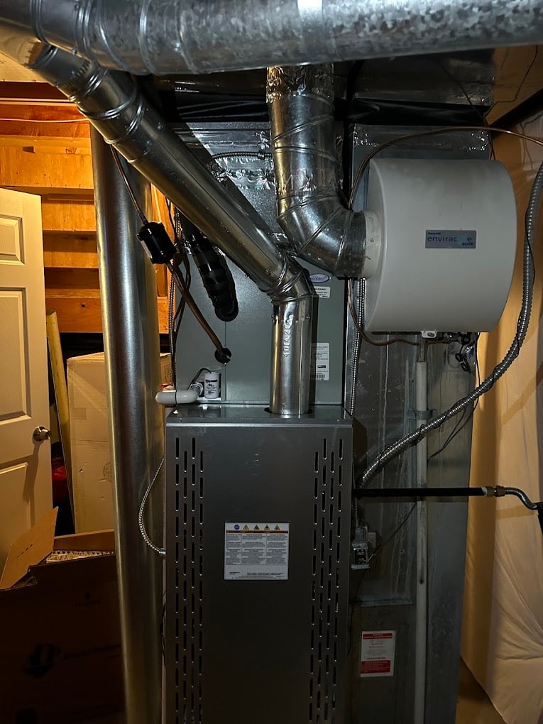 Vertical gas furnace installed in a tight utility space with clean venting and code-compliant clearances.